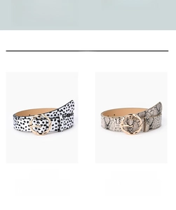 Detailed close-up of fashion waist belts with leopard and polka dot patterns and gold buckles