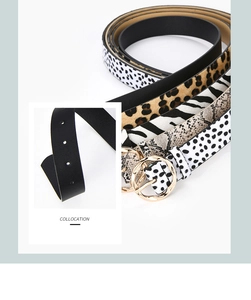 Close-up of animal print wide belts with round gold buckles and precision holes