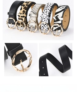Detail of five patterned belts featuring gold round buckles and leopard animal prints