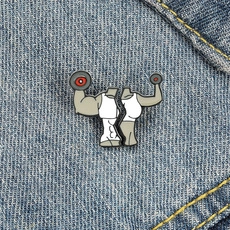 Detail view of fitness enamel pins with dumbbell design pinned on blue denim fabric
