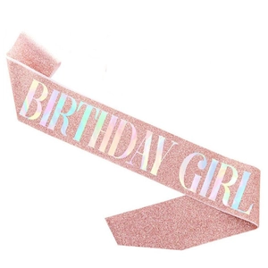 Detail of pink glitter Birthday Girl sash with holographic iridescent lettering print