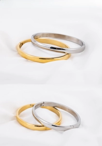 Detailed view of 6mm polished 18K gold and silver plated stainless steel bangles