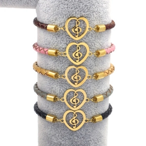 Detail showing five colors of braided leather bracelets with musical note heart pendants