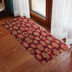 Red Christmas runner rug with gold snowflakes on wood floor with white curtains