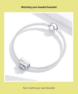 Detailed view of silver mesh bracelet with camera charm and Forever Love engraving