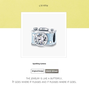 Macro shot of S925 sterling silver camera charm with blue enamel and cubic zirconia