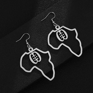 Macro shot of silver African continent earrings with Adinkra Gye Nyame symbol
