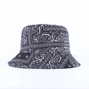 Detail shot of the paisley pattern print on the black and white reversible bucket hat