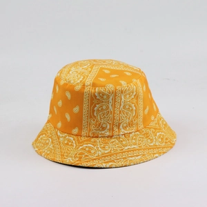 Detail of orange paisley bucket hat with white bandana print on a white background