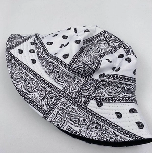 Detail of white reversible bucket hat with black paisley pattern and durable stitching