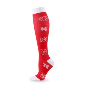 Red Christmas compression socks featuring white snowflakes and reinforced heel for sports