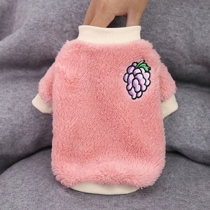 Close-up of pink coral fleece dog sweater with purple grape embroidery and ribbed cuffs