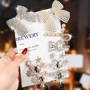 Detailed set of elegant pearl and rhinestone hair clips featuring bows and star designs