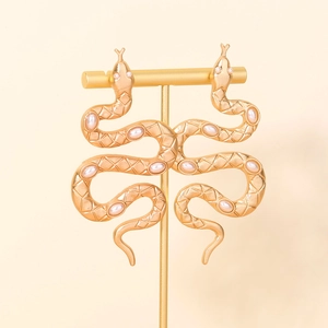 Vintage matte gold snake earrings with textured scales and elegant white pearl accents