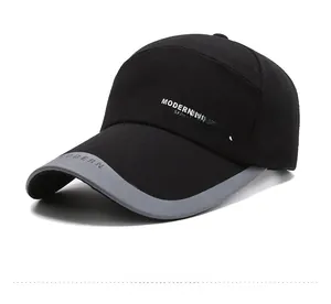 Detail of grey-black baseball cap featuring side embroidery and contrast curved brim