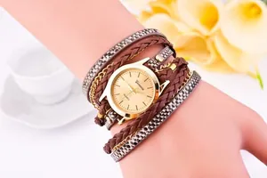 Close-up of leopard print wrap watch with gold chains and woven leather on a model's wrist