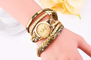 Detail of leopard print leather bracelet watch with gold case on a person's wrist