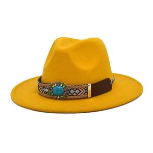 Dettaglio cappello fedora in lana gialla con fascia etnica e pietra turchese