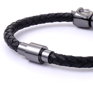 Punk style braided black leather men's bracelet with a sleek skull metal clasp