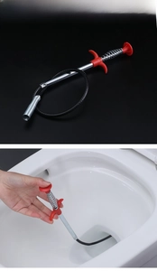 Macro detail of a flexible spring sink drain claw tool clearing debris from a toilet