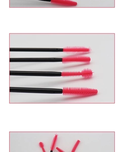 Detail of pink silicone eyelash brush heads with black handles in various spiral shapes