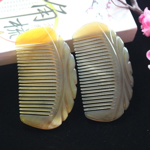 Macro view of natural yak horn hair combs with exquisite leaf carving and marble texture