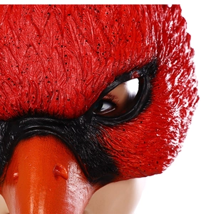 Close-up of red bird mask showing realistic latex feather textures and eye details