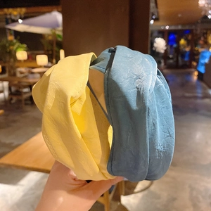 Detail of vintage knotted faux leather headbands in pale yellow and dusty blue colors