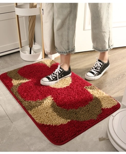 Close-up of red Chinese-style entryway rug with non-slip texture and circular patterns