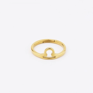 Detail of 18k gold Libra zodiac sign ring with adjustable open band and polished finish
