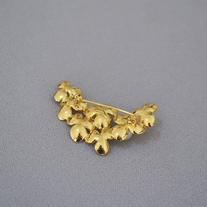 Elegant gold flower leaf brooch with pearl accents and detailed pin clasp closure