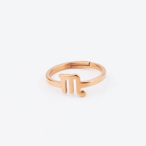 Macro view of Scorpio zodiac sign on rose gold stainless steel open ring detail