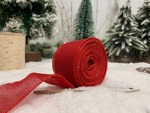 Red plaid burlap ribbon for Christmas decor set against a snowy winter scene background