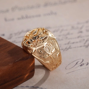 Macro shot of gold vintage ring featuring Egyptian Ankh relief and detailed engravings