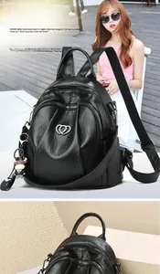 Detail of black lychee grain leather backpack with silver heart logo and calf charm