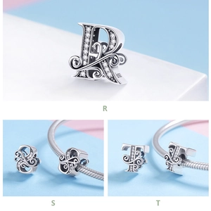 Macro view of S925 sterling silver charms with zircon inlay for letters R, S, and T