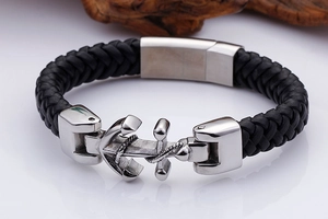 Close-up of black braided leather bracelet with a polished silver steel anchor clasp