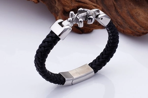 Detailed 45-degree angle of black woven leather strap and silver stainless steel anchor clasp
