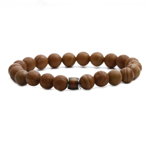Macro detail of natural stone mood beads with brown patterns and center barrel bead accent