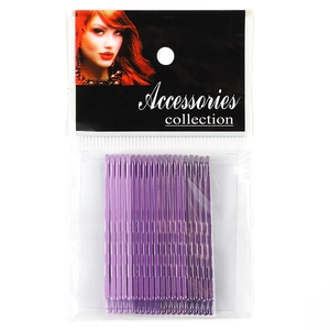 Close-up of glitter purple wavy bobby pins in transparent packaging with a white card