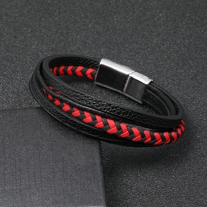 Close-up of multilayer leather bracelet with red weaving and silver magnetic clasp