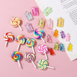 Flat lay of colorful resin candy charms and sweet bags for DIY jewelry making