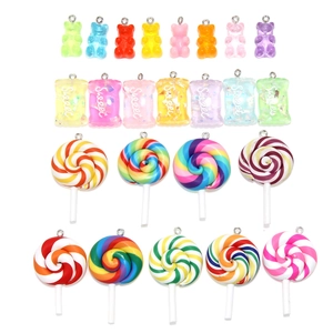 Flat lay of colorful resin gummy bear and glitter candy charms for DIY jewelry making
