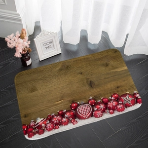 Detail view of a Christmas flannel floor mat with festive ornaments on a wooden floor