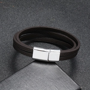 Detail of multi-layer brown leather bracelet with silver magnetic metal clasp for men