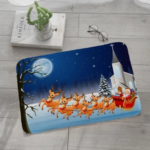Detailed view of flannel Christmas mat with Santa and reindeer on wooden floor