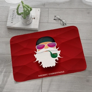 Detail of red Christmas flannel mat on wooden floor with modern Santa and Merry Christmas text