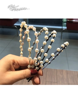 Detail view of pearl-beaded headbands in five colors with white faux pearls