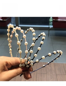Detail view of multicolored woven pearl headbands featuring elegant white beads