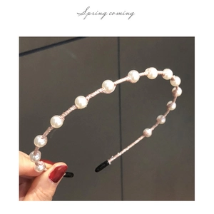 Detail shot of vintage pearl headband with woven wire and shimmering rhinestones